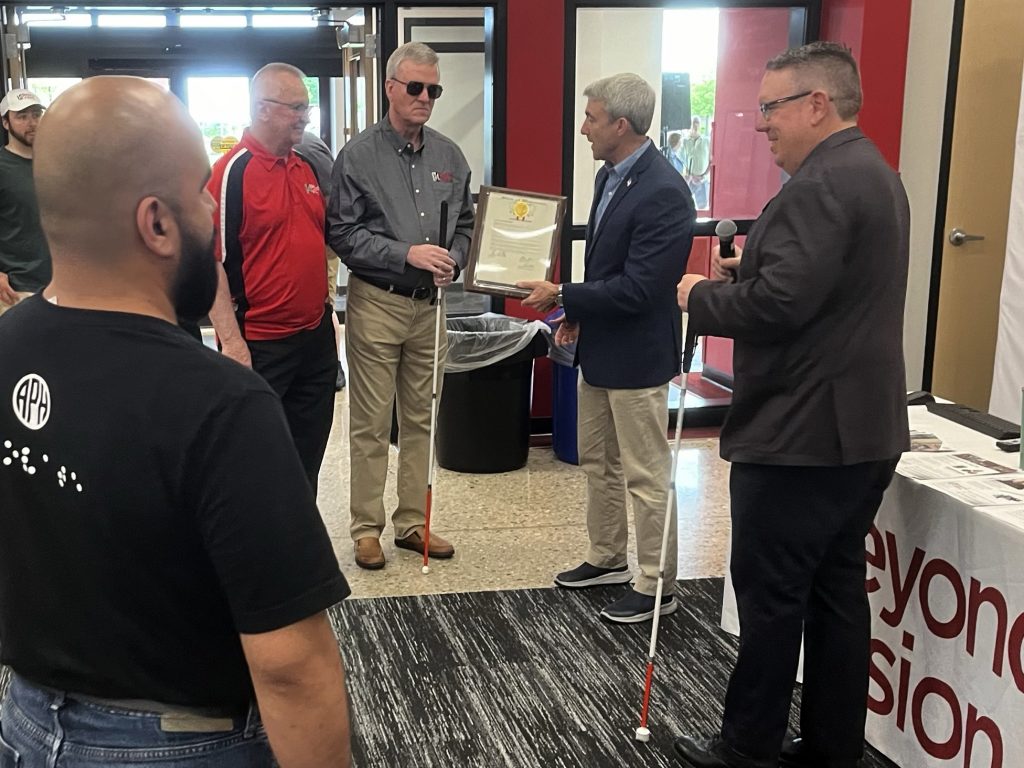 Senator Hutton presenting Jim Kerlin and the Chairman of our Board, Mike Chew a proclamation.