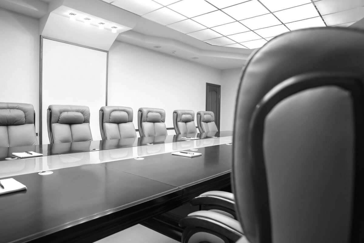 Photograph of a row of chairs in a meeting room.